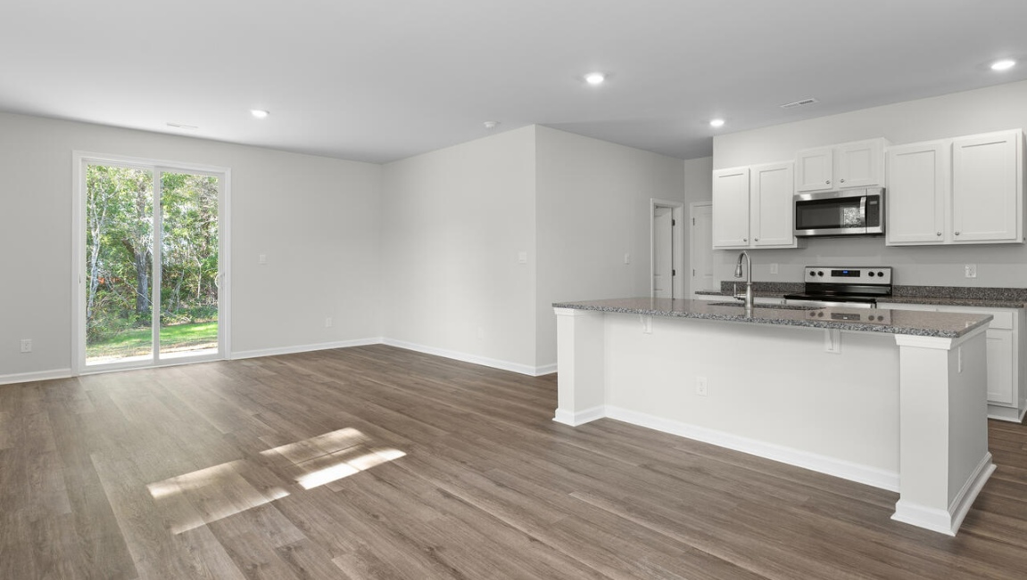 he gourmet kitchen stands out with its elegant granite or granite countertops. tile backsplash and stainless steel appliance package.