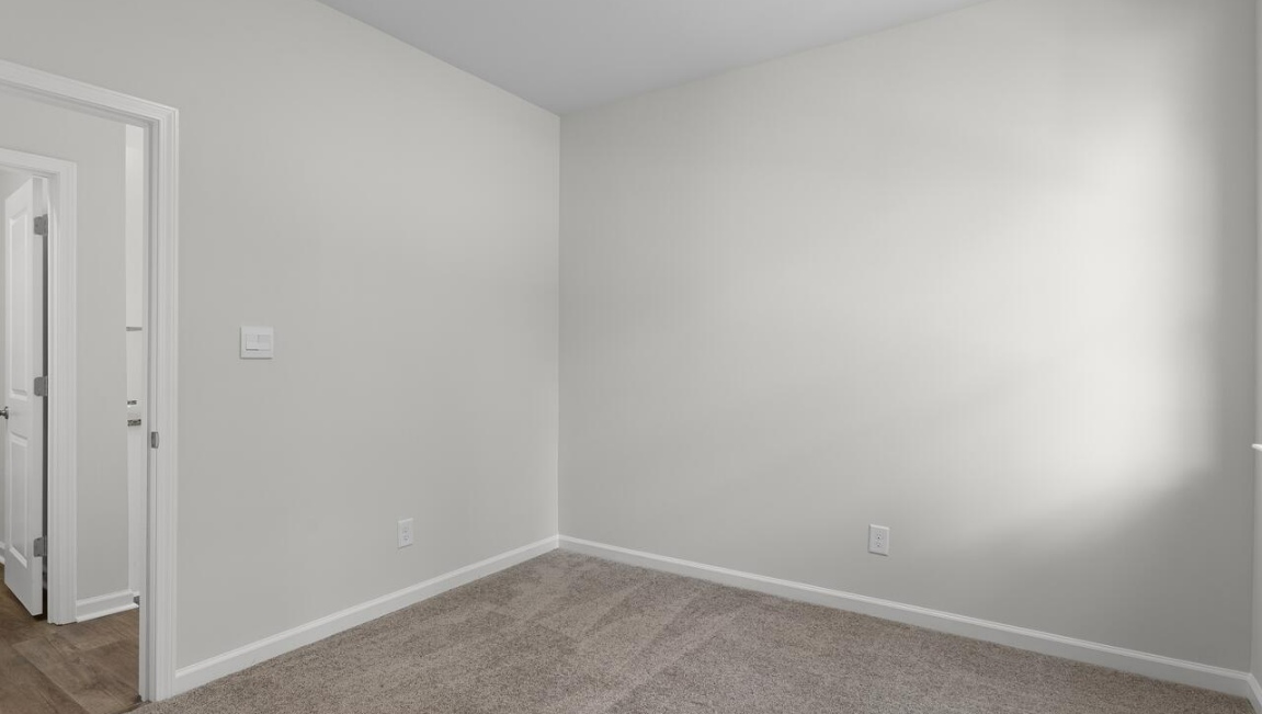 This home provides a guest room or office on the ground floor along with the primary suite and 2 additional bedrooms upstairs.