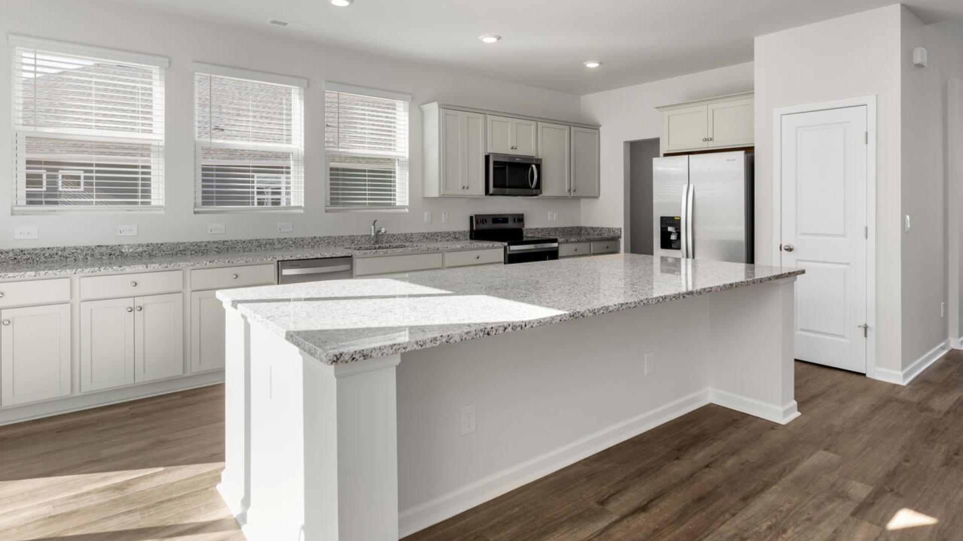 On the first floor, the formal dining room is ideally located next to a spacious open-concept living area and kitchen, allowing for effortless interaction with guests while preparing meals.