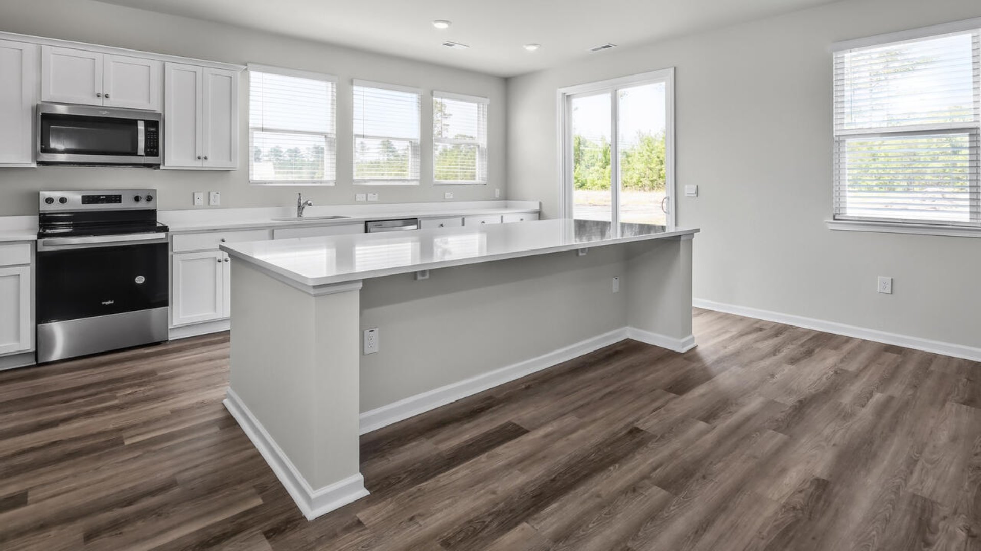 An extra-large kitchen island offers ample room for cooking and hosting, with the outdoor patio being perfect for grilling or relaxing in the fresh air