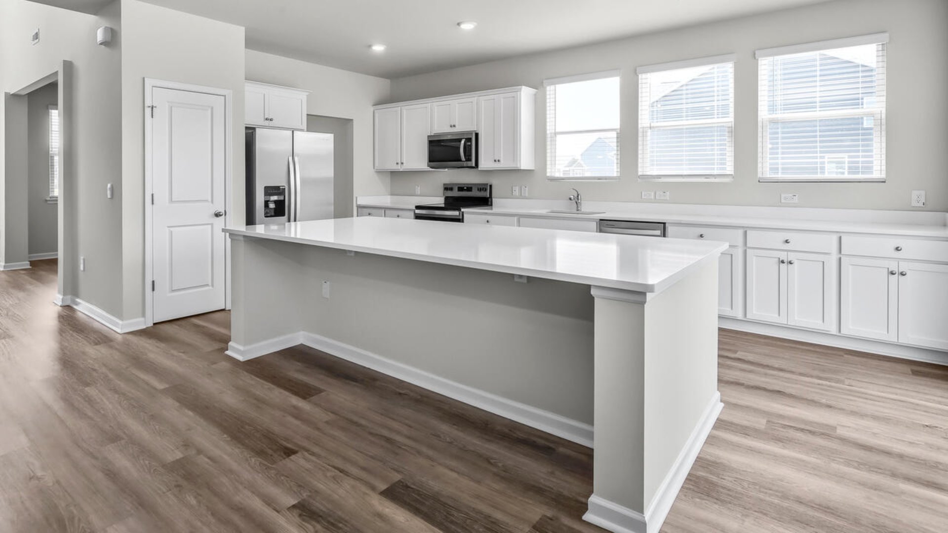 An extra-large kitchen island offers ample room for cooking and hosting, with the outdoor patio being perfect for grilling or relaxing in the fresh air