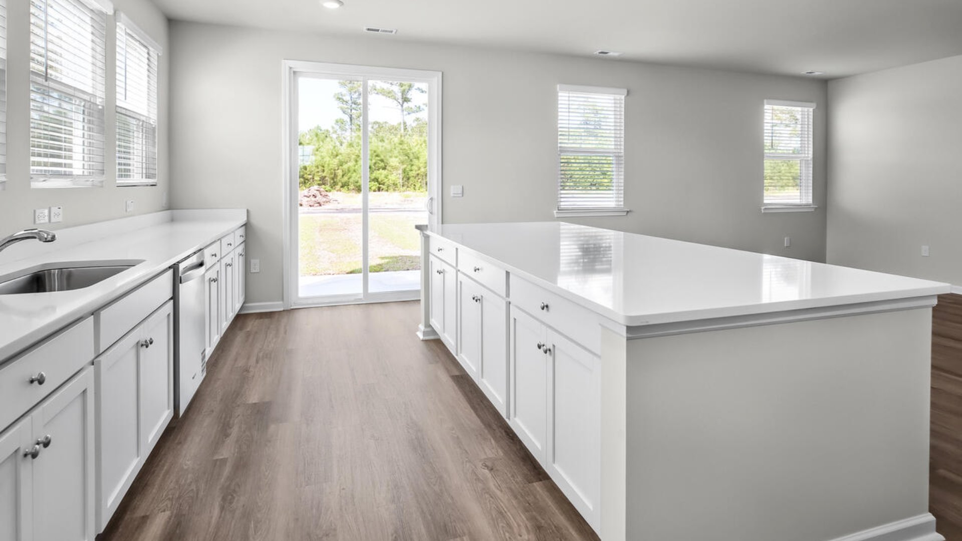 An extra-large kitchen island offers ample room for cooking and hosting, with the outdoor patio being perfect for grilling or relaxing in the fresh air
