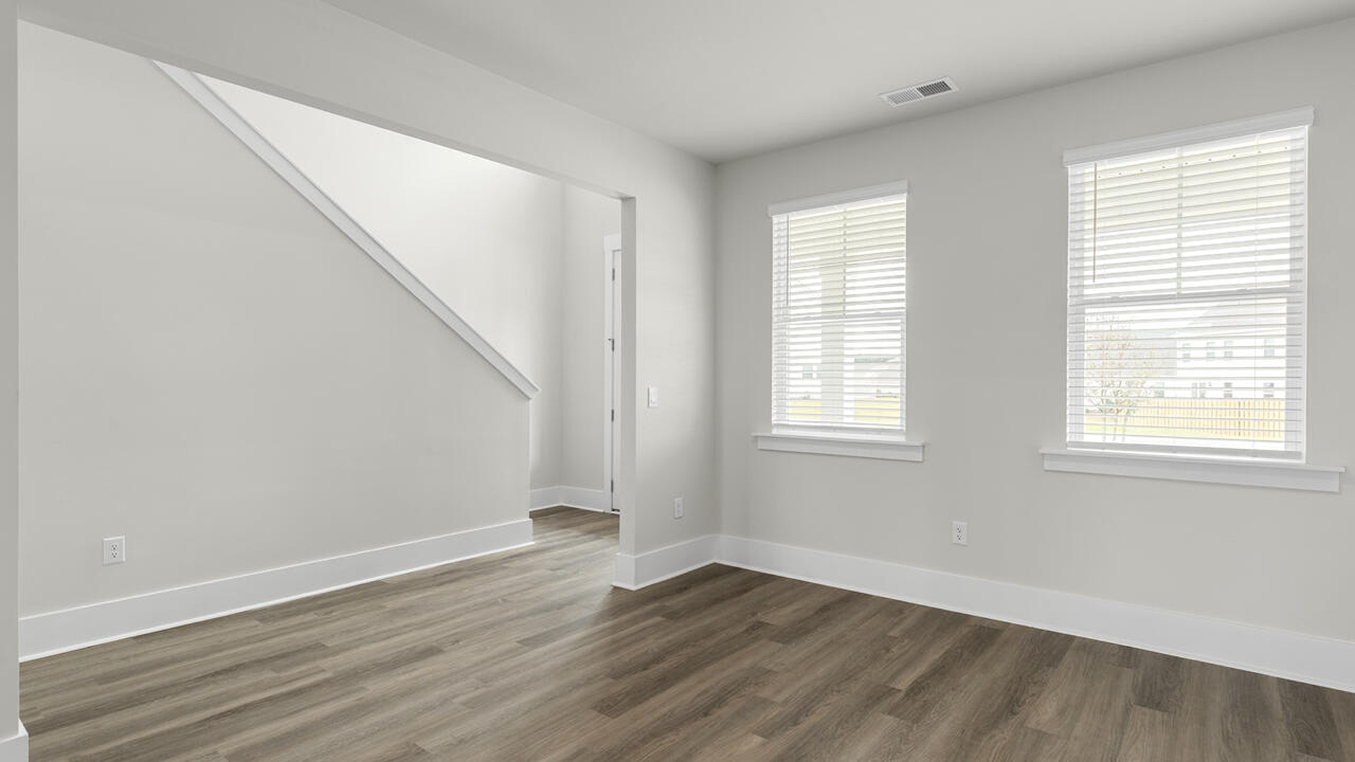 On the first floor, the formal dining room is ideally located next to a spacious open-concept living area and kitchen, allowing for effortless interaction with guests while preparing meals.