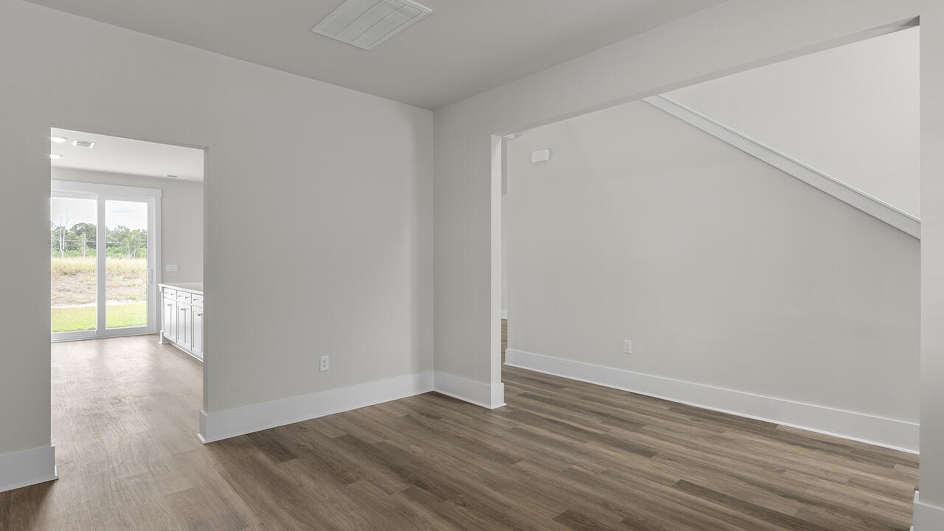 On the first floor, the formal dining room is ideally located next to a spacious open-concept living area and kitchen, allowing for effortless interaction with guests while preparing meals.