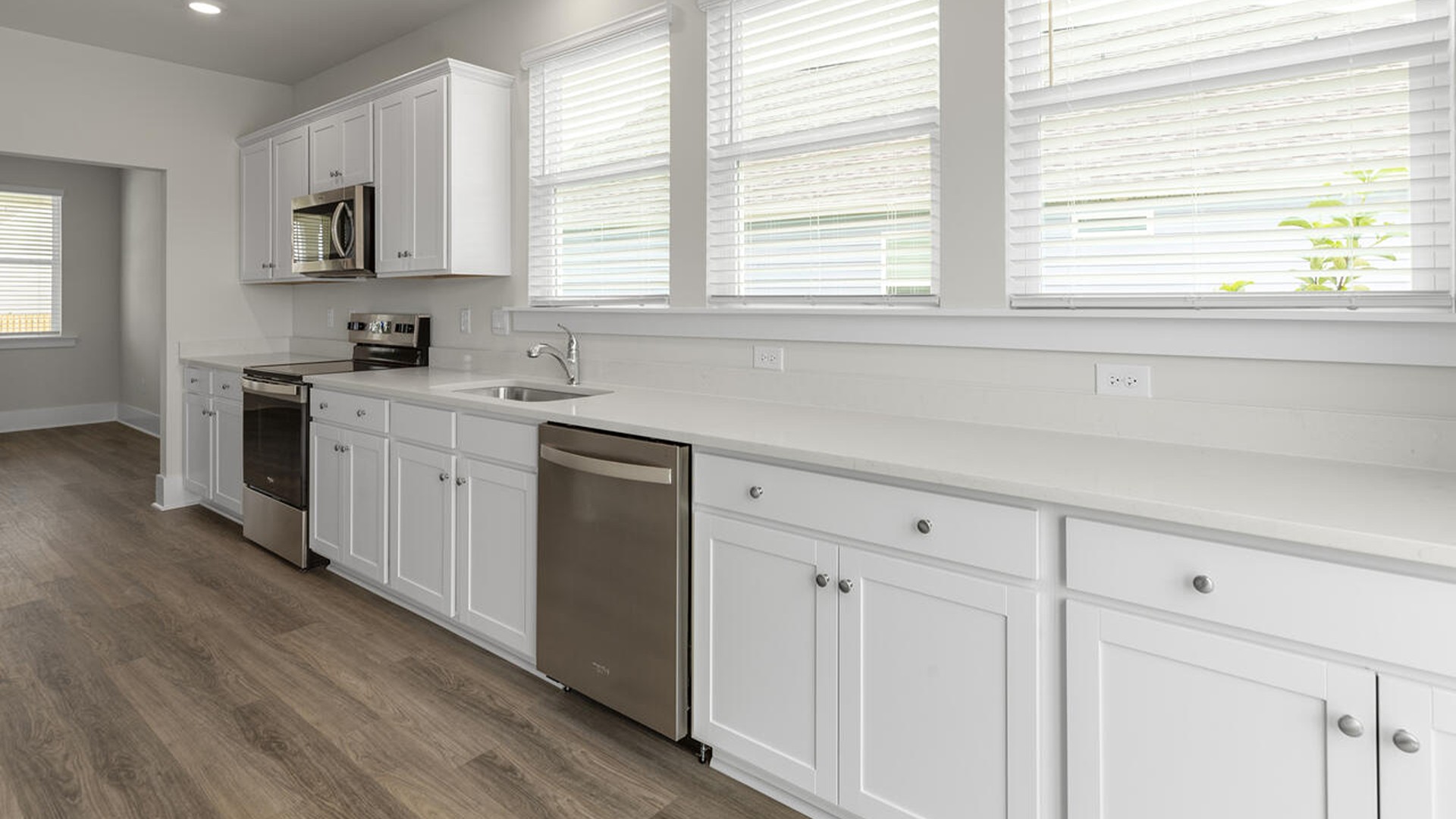 A large kitchen featuring granite countertops, stainless steel appliances and an island that offers ample room for food preparation and casual dinin