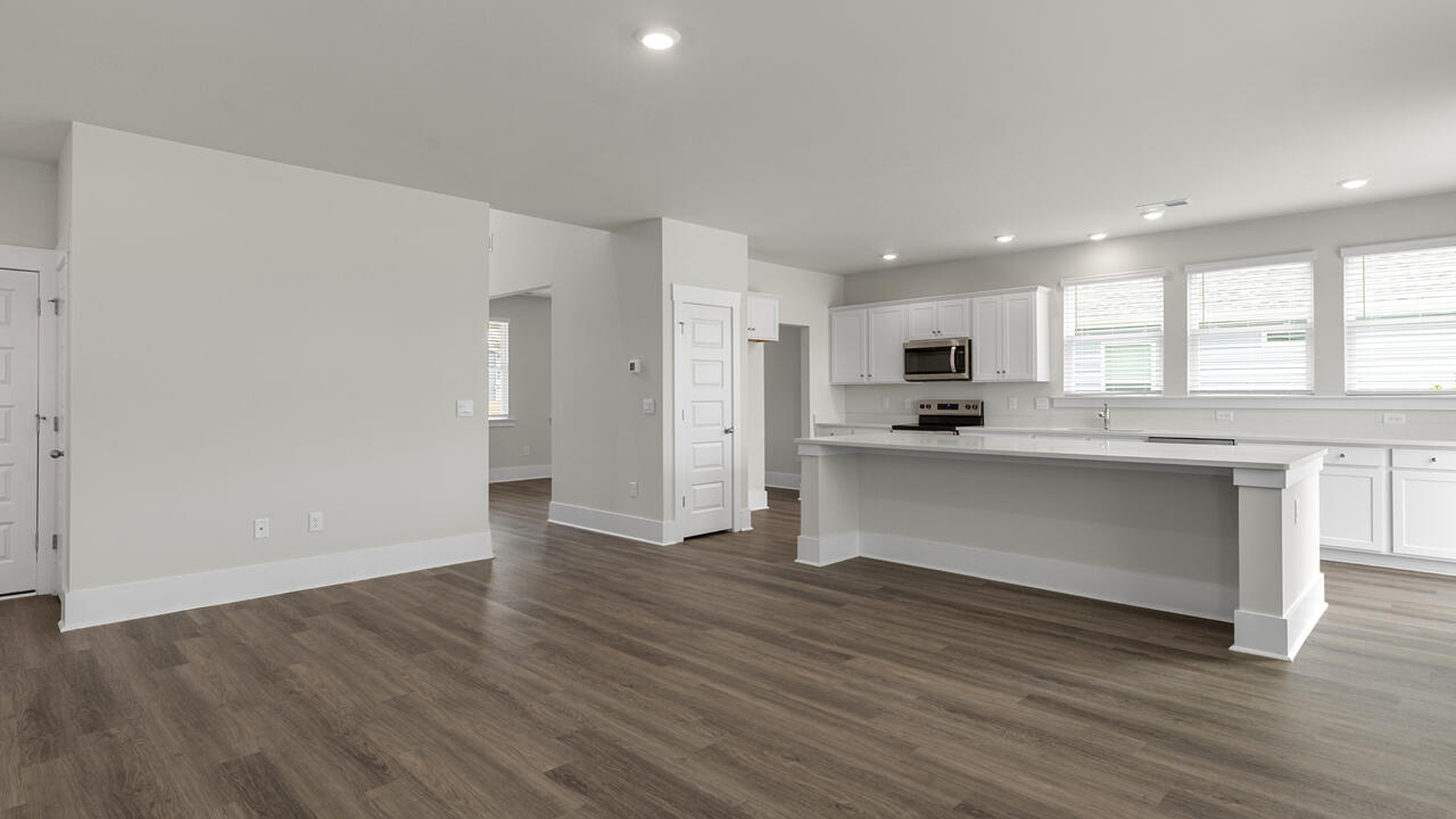 On the first floor, the formal dining room is ideally located next to a spacious open-concept living area and kitchen, allowing for effortless interaction with guests while preparing meals.