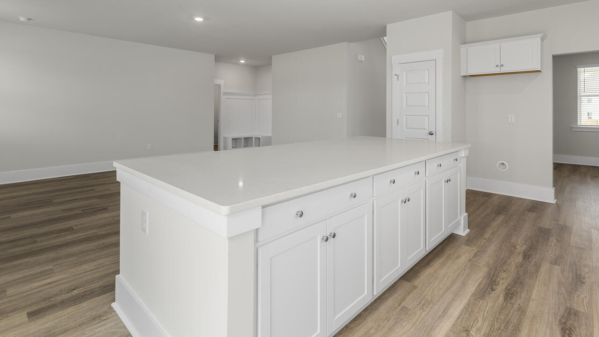 A large kitchen featuring granite countertops, stainless steel appliances and an island that offers ample room for food preparation and casual dining