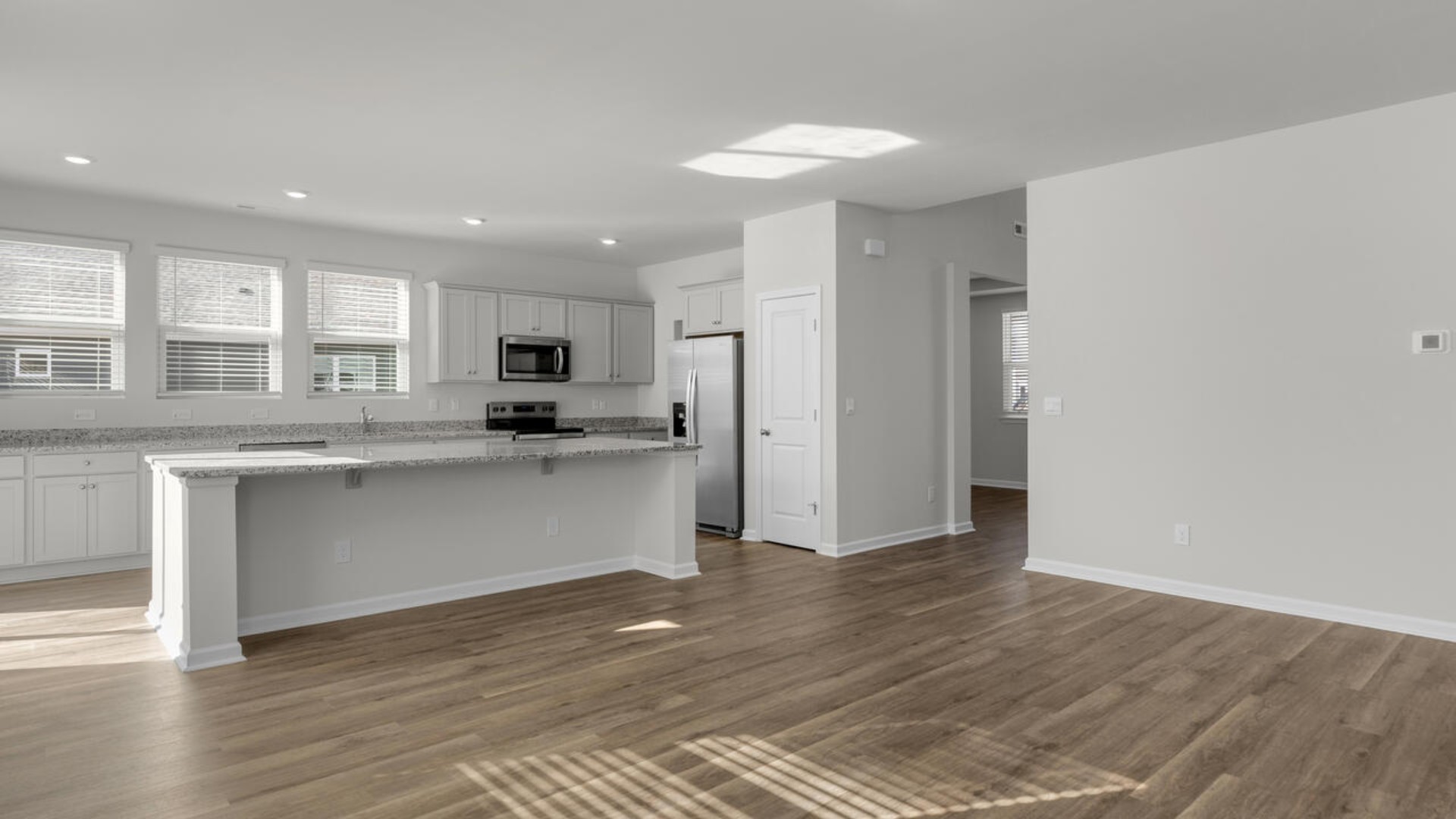 Open floor plan with giant granite island open large gourmet kitchen with 36'' cabinets with crown molding, granite countertops, tile backsplash, and pantry, and stainless-steel appliances in kitchen. Separate dining room just right for entertaining.