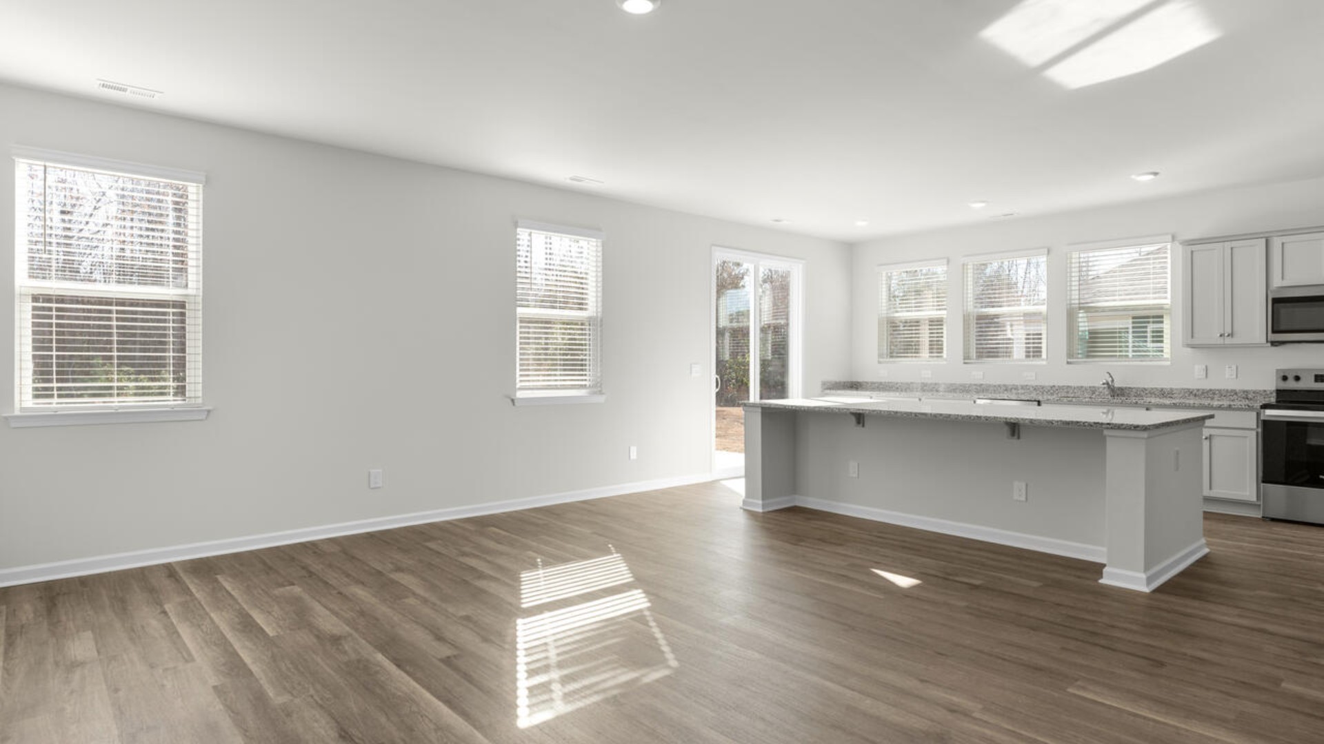 Open floor plan with giant granite island open large gourmet kitchen with 36'' cabinets with crown molding, granite countertops, tile backsplash, and pantry, and stainless-steel appliances in kitchen. Separate dining room just right for entertaining.