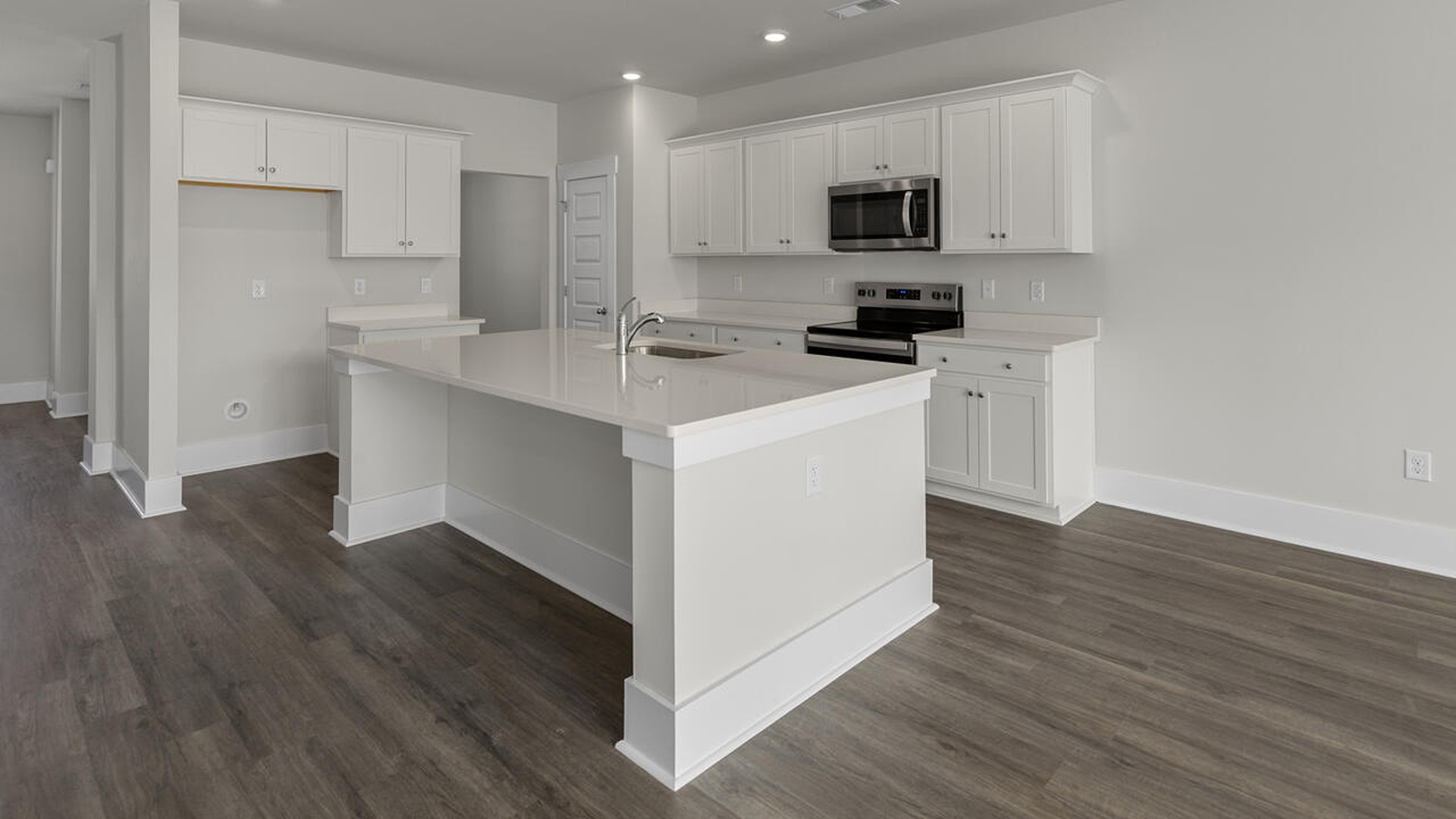 As you enter the home you will find a formal dining room, open concept kitchen and family room with additional seating at the large kitchen island, and a first floor primary bedroom retreat.