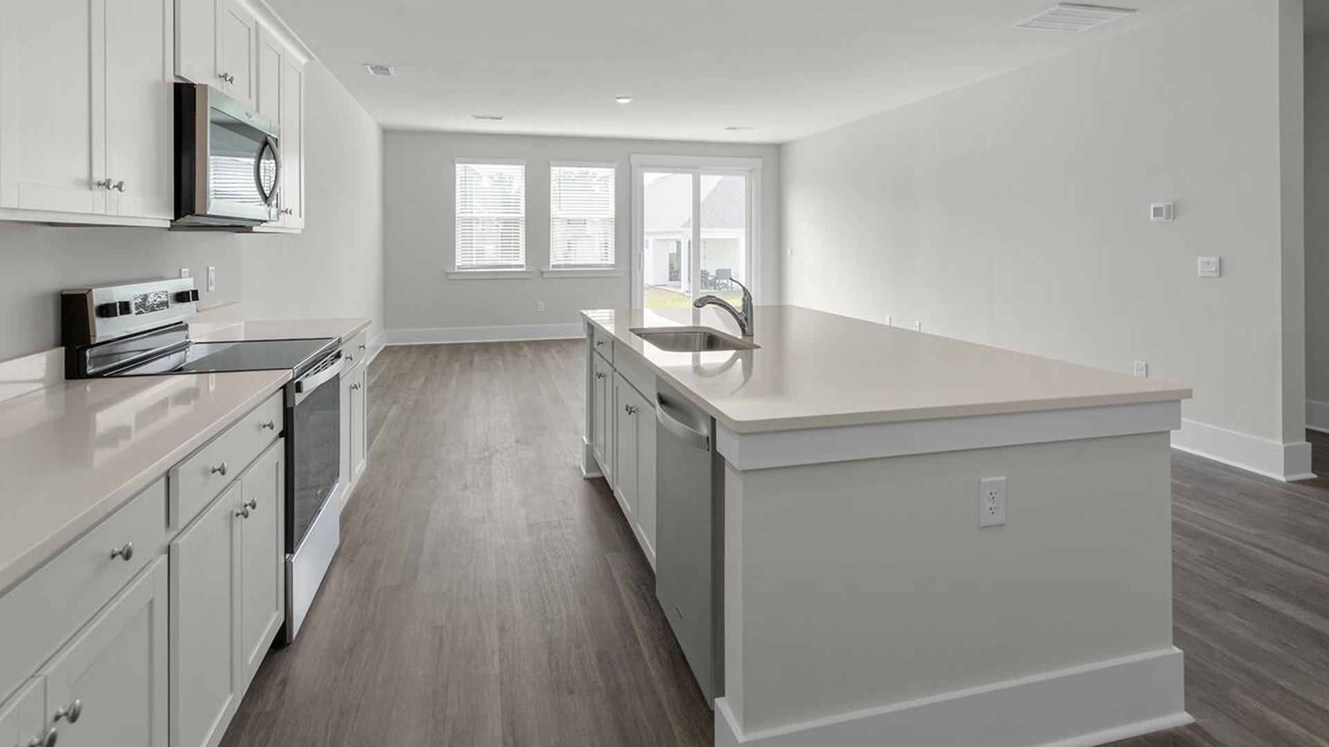 As you enter the home you will find a formal dining room, open concept kitchen and family room with additional seating at the large kitchen island, and a first floor primary bedroom retreat.