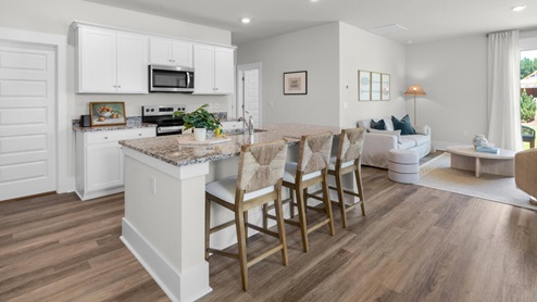 The kitchen features shaker-style cabinets, granite countertops, and stainless steel appliances, which are sure to both turn heads and make meal prep easy. You’ll never be too far from the action with the living and dining area right there.