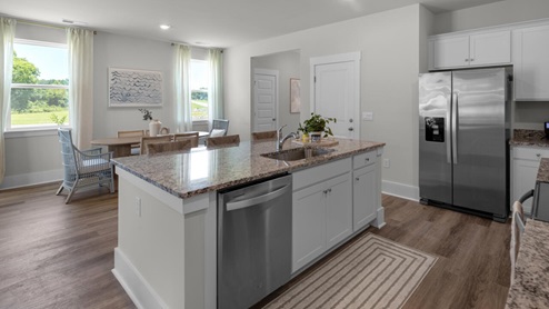 The kitchen features shaker-style cabinets, granite countertops, and stainless steel appliances, which are sure to both turn heads and make meal prep easy. You’ll never be too far from the action with the living and dining area right there.