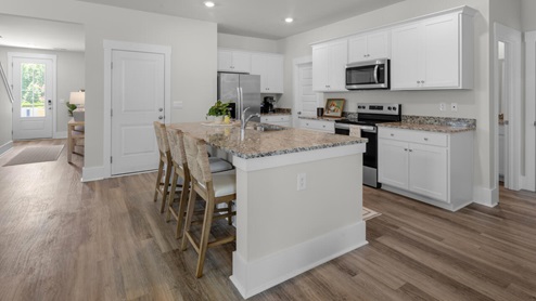 The kitchen features shaker-style cabinets, granite countertops, and stainless steel appliances, which are sure to both turn heads and make meal prep easy. You’ll never be too far from the action with the living and dining area right there.