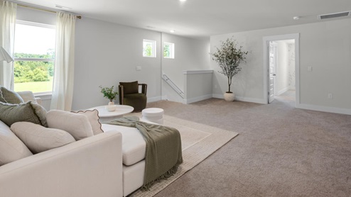 This home provides a guest room or office on the ground floor along with the primary suite and 2 additional bedrooms upstairs. It includes a generous upstairs loft that can serve as an entertainment area, play space, or office. The Woodstock comes with a 2-car garage.