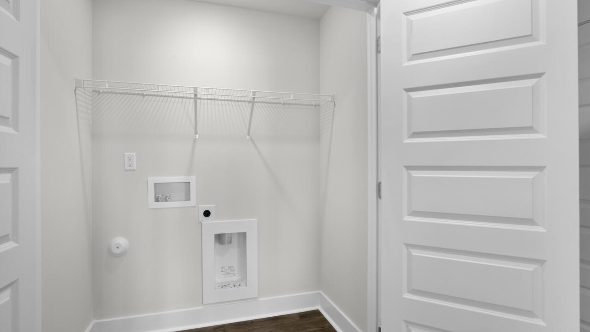 . It also includes two additional bedrooms, a shared bathroom, and a laundry room for convenience.