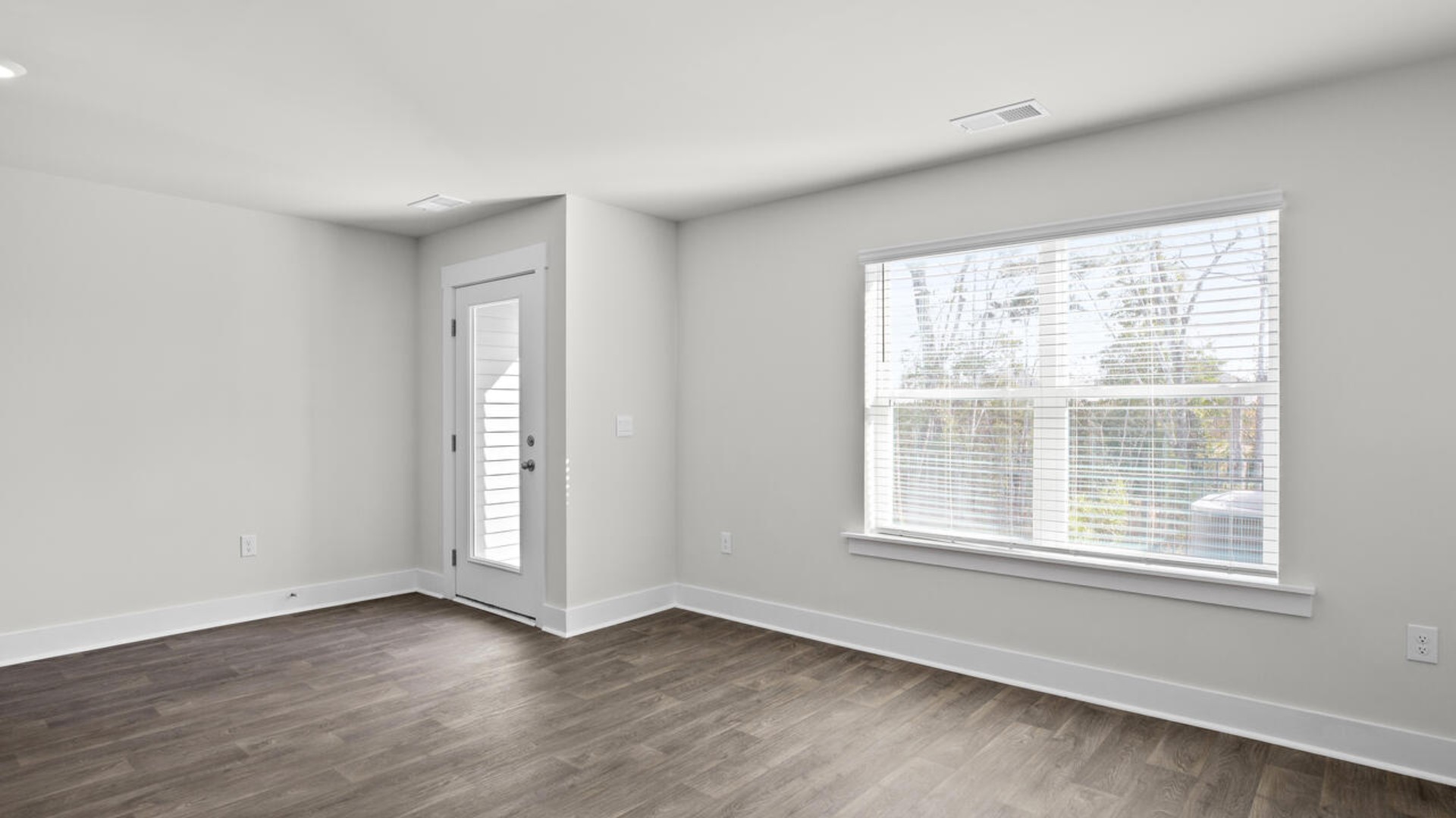 The kitchen overlooks the dining and living spaces, ideal for entertaining guests or enjoying family time while preparing meals with new stainless-steel appliances and granite countertops.
