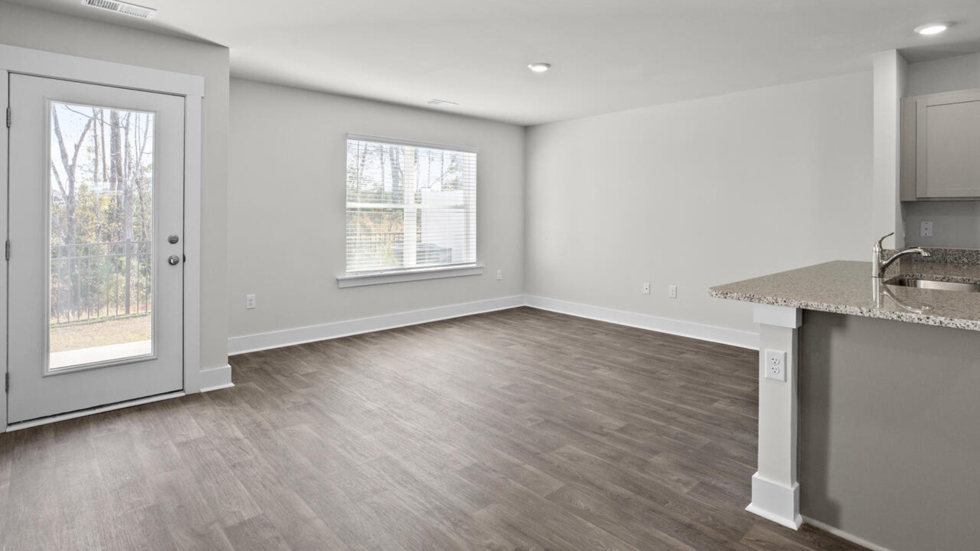 The living area is an open concept, where your kitchen, living, and dining areas blend seamlessly into a space perfect for everyday living and entertaining. The first floor also has a half bathroom.
