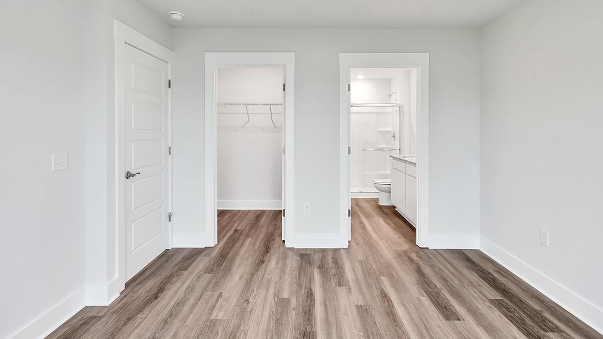 The Primary bedroom is located on the first floor with a large primary suite and bath with double vanities and walk in shower.