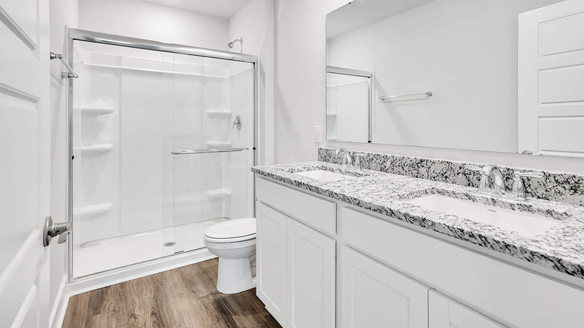 The Primary bedroom is located on the first floor with a large primary suite and bath with double vanities and walk in shower.