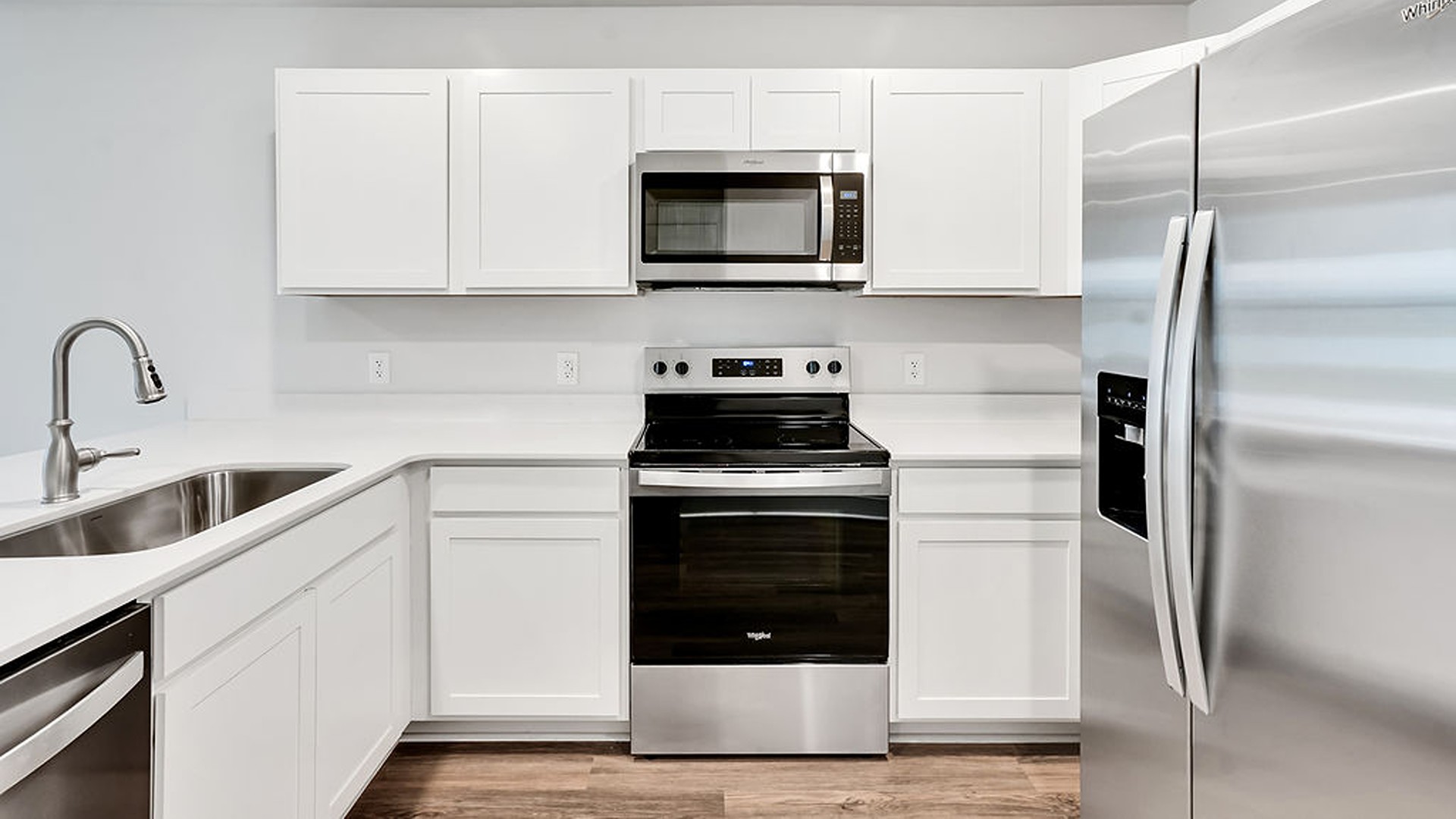 The kitchen features shaker-style cabinets, granite countertops, and stainless-steel appliances, which are sure to both turn heads and make meal prep easy.