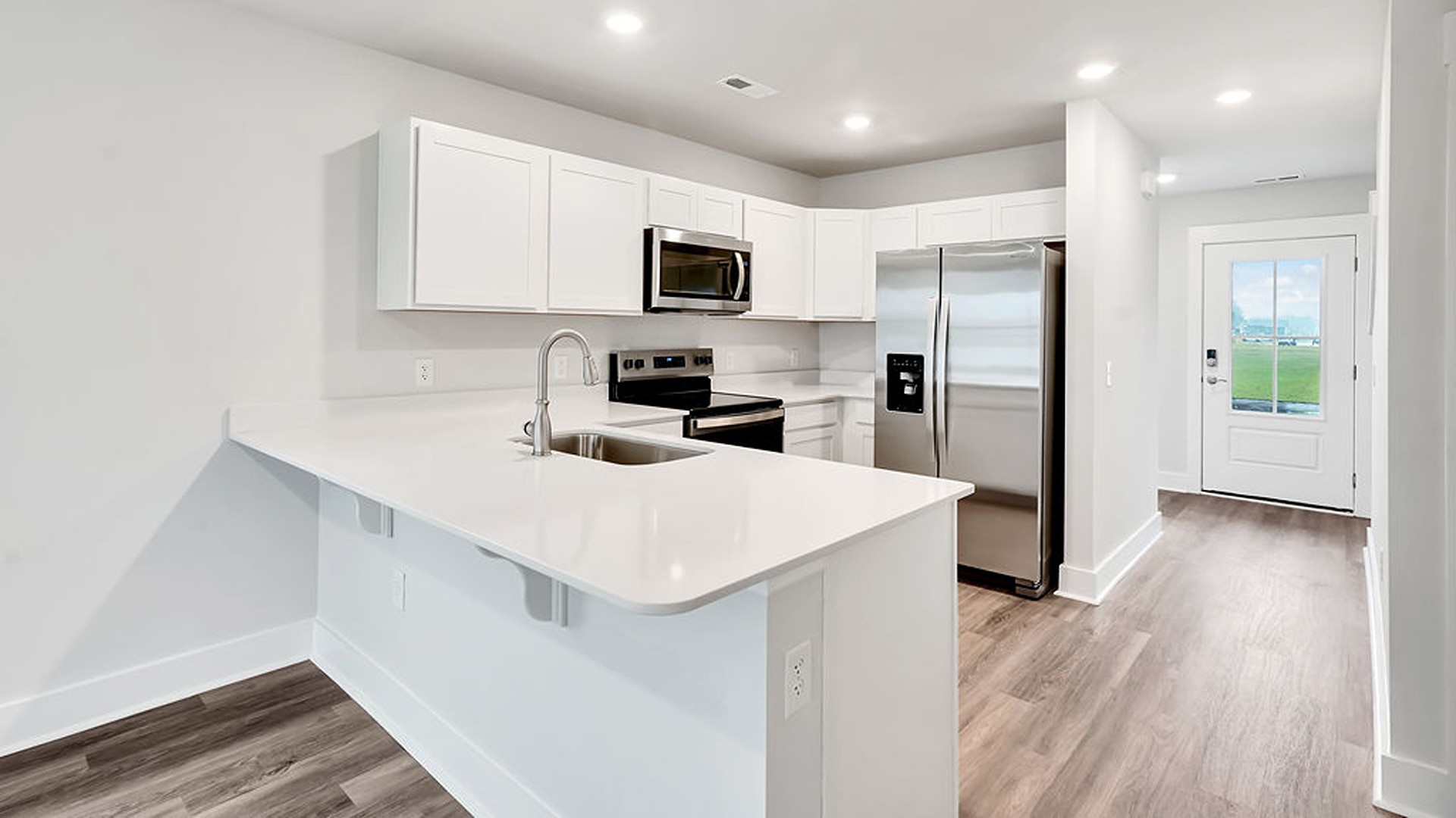 The kitchen features shaker-style cabinets, granite countertops, and stainless-steel appliances, which are sure to both turn heads and make meal prep easy.