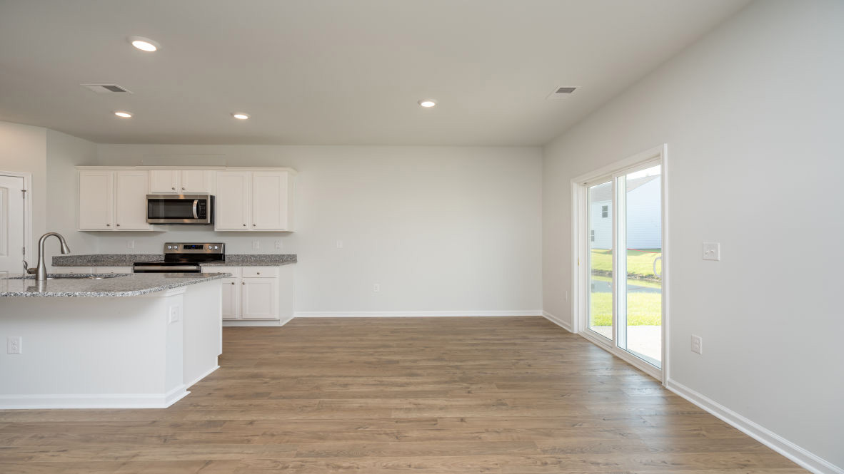 Its open-concept design includes a kitchen with Granite countertops, Stainless Steel Appliances, an island, and a walk-in pantry, while the large Great Room is ideal for entertaining.