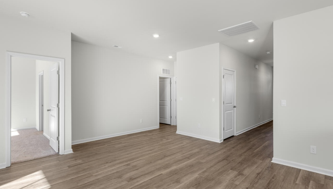 New Homes in Leland NC. The Kerry floor plan offers open living space and a 2-car garage. At the front are two guest bedrooms and a full bathroom, perfect for visitors or a home office. The open-concept family room, kitchen, and dining area feature Granite countertops, stainless steel appliances, including a smooth-top range, dishwasher and overhead microwave