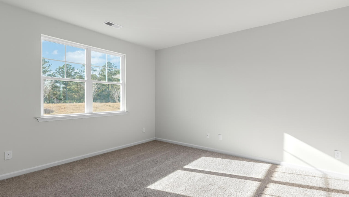 New Homes in Leland NC. The Kerry floor plan offers open living space and a 2-car garage. At the front are two guest bedrooms and a full bathroom, perfect for visitors or a home office. The open-concept family room, kitchen, and dining area feature Granite countertops, stainless steel appliances, including a smooth-top range, dishwasher and overhead microwave