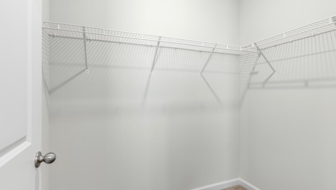 New Homes in Leland NC. The Kerry floor plan offers open living space and a 2-car garage. At the front are two guest bedrooms and a full bathroom, perfect for visitors or a home office. The open-concept family room, kitchen, and dining area feature Granite countertops, stainless steel appliances, including a smooth-top range, dishwasher and overhead microwave