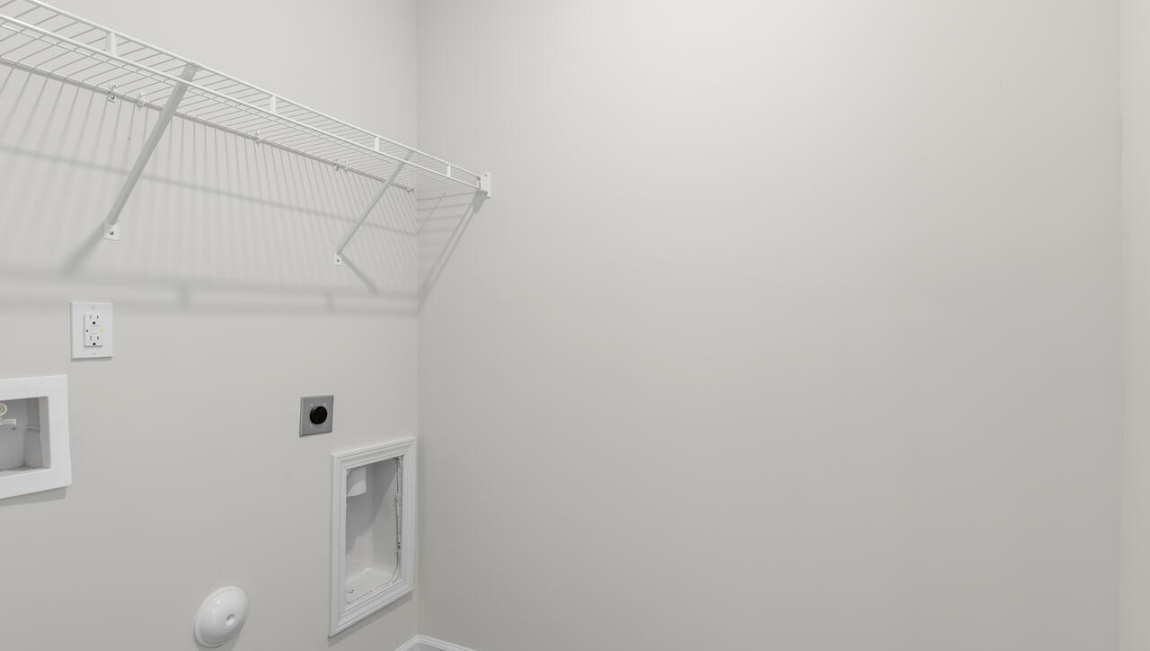 New Homes in Leland NC. The Kerry floor plan offers open living space and a 2-car garage. At the front are two guest bedrooms and a full bathroom, perfect for visitors or a home office. The open-concept family room, kitchen, and dining area feature Granite countertops, stainless steel appliances, including a smooth-top range, dishwasher and overhead microwave