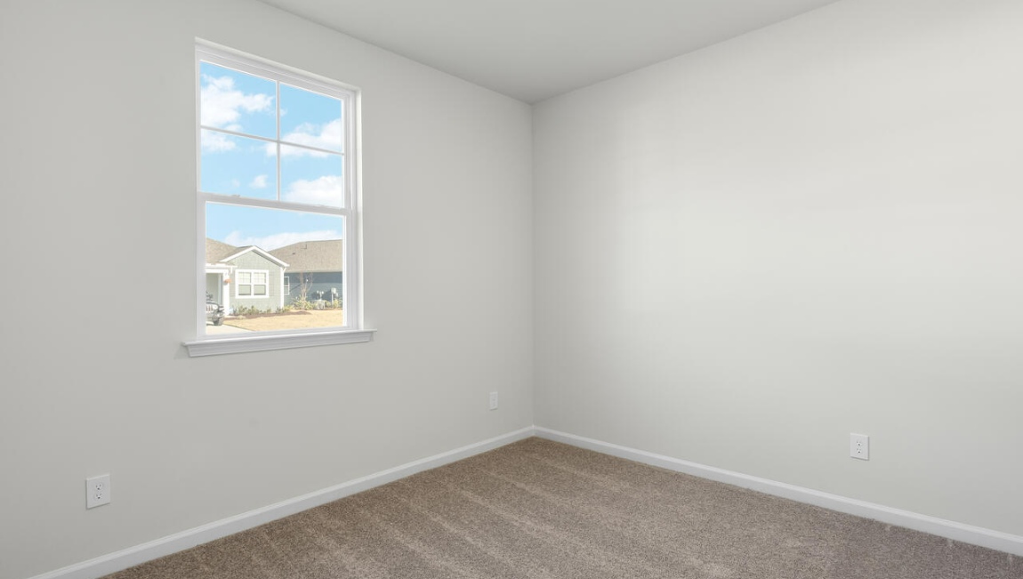 New Homes in Leland NC. The Kerry floor plan offers open living space and a 2-car garage. At the front are two guest bedrooms and a full bathroom, perfect for visitors or a home office. The open-concept family room, kitchen, and dining area feature Granite countertops, stainless steel appliances, including a smooth-top range, dishwasher and overhead microwave