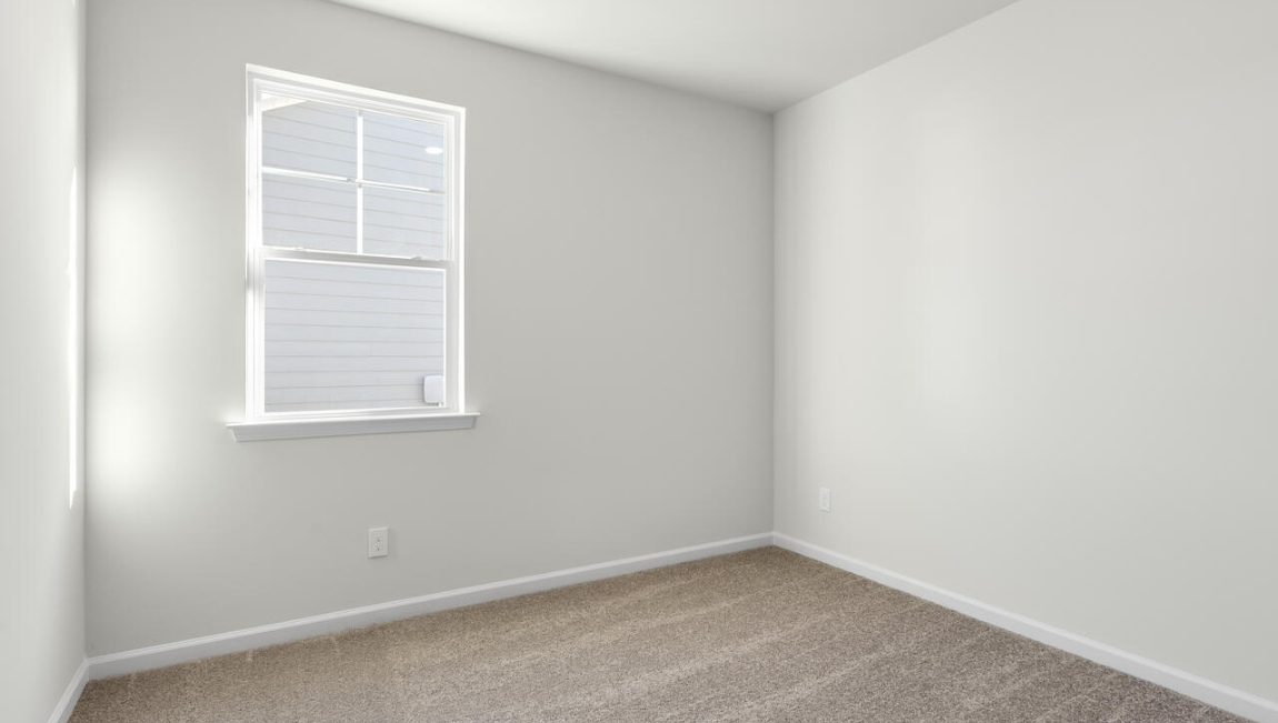 New Homes in Leland NC. The Kerry floor plan offers open living space and a 2-car garage. At the front are two guest bedrooms and a full bathroom, perfect for visitors or a home office. The open-concept family room, kitchen, and dining area feature Granite countertops, stainless steel appliances, including a smooth-top range, dishwasher and overhead microwave