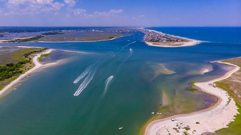 Discover white sand and sparkling water along the beach and the Intracoastal Waterway just begging for watersports activities, swimming, sunbathing, beachcombing, fishing and surfing. Named one of the last best American beach towns, Wrightsville Beach is known for its clean, spacious beach and picturesque setting. Strolling about the village-like town offers scenic views no matter whether you are oceanfront, harbor side or at a marina. It’s a place so magical the sun both rises and sets over the water. Generations have visited this beach destination voted North Carolina’s best beach.