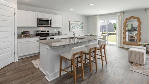 The kitchen features beautiful cabinets, granite countertops, and stainless steel appliances, which are sure to both turn heads and make meal prep easy. You’ll never be too far from the action with the living and dining area right there.