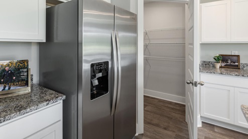 The kitchen features beautiful cabinets, granite countertops, and stainless steel appliances, which are sure to both turn heads and make meal prep easy. You’ll never be too far from the action with the living and dining area right there.