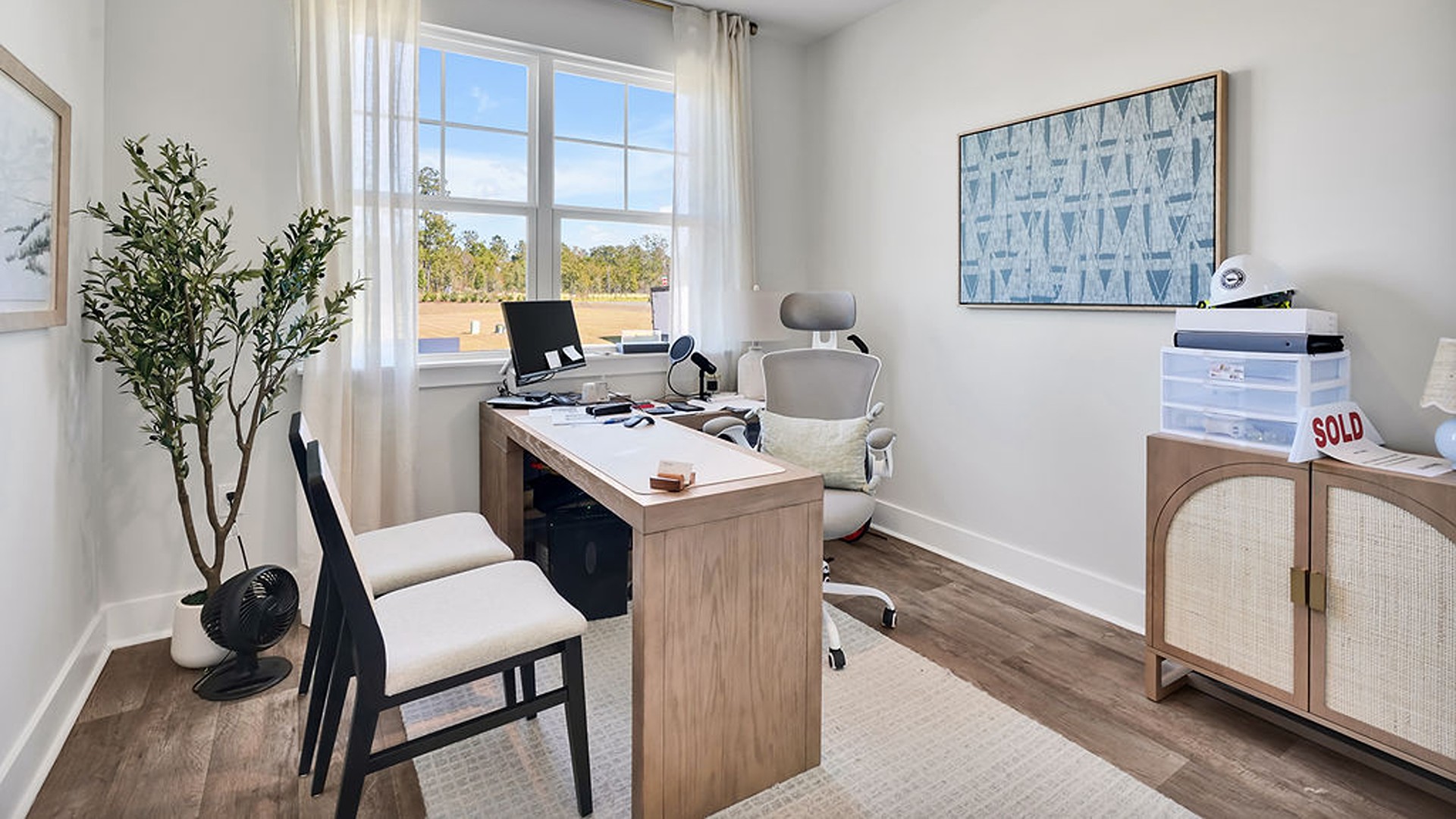 The kitchen boasts stainless steel appliances, a walk-in pantry, and a generous island that flows seamlessly into the main living area. Durable luxury vinyl plank flooring runs throughout the first floor, designed to handle your beach days year-round.
