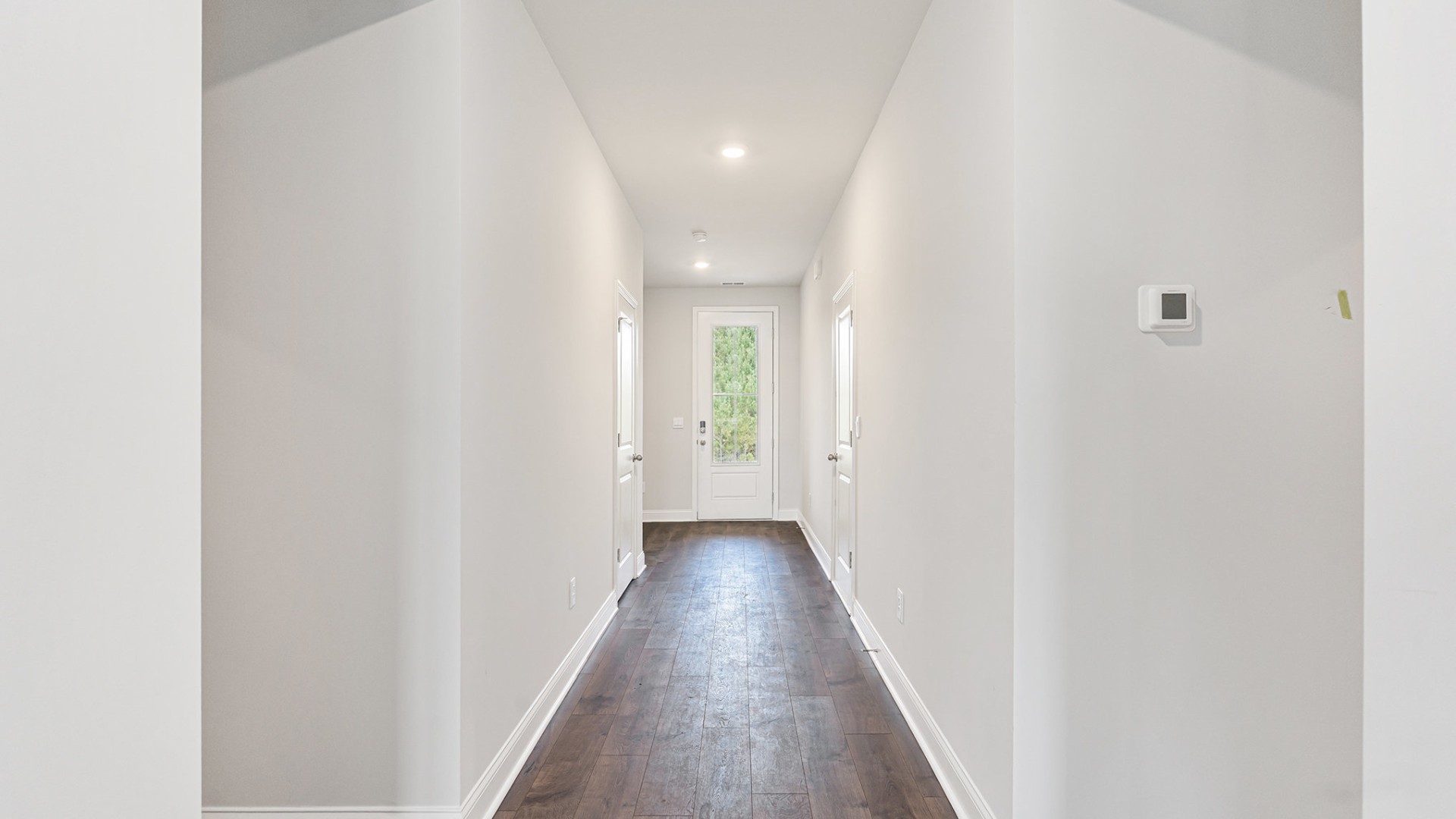 The open-concept kitchen shines with granite countertops, a stylish tile backsplash, a large island, and LVP flooring that extends through the main living areas.