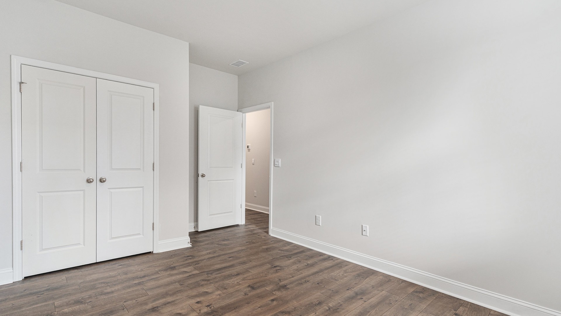 The primary bedroom provides a private retreat with a large walk-in closet and en-suite bathroom featuring dual vanities and a relaxing shower.