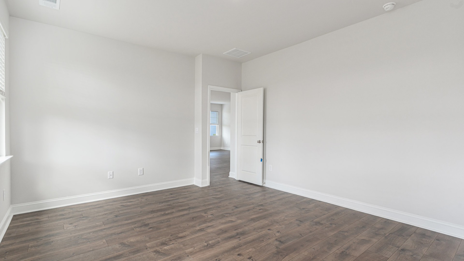 The primary bedroom provides a private retreat with a large walk-in closet and en-suite bathroom featuring dual vanities and a relaxing shower.