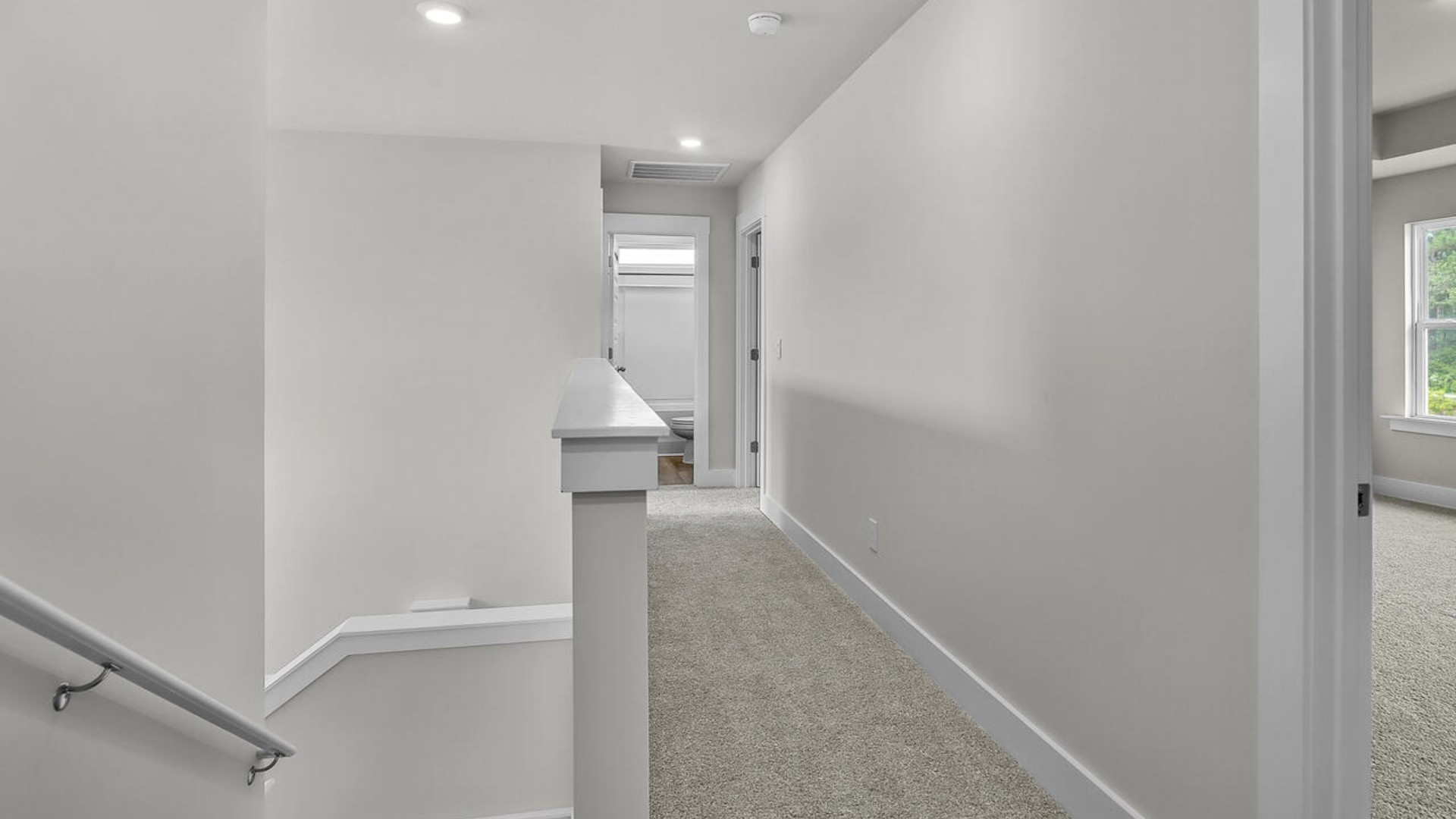 The primary suite features a sitting room, walk-in closet, trayed ceiling, a step-in 5-foot shower, dual vanity with granite countertops, and natural light in the bathroom