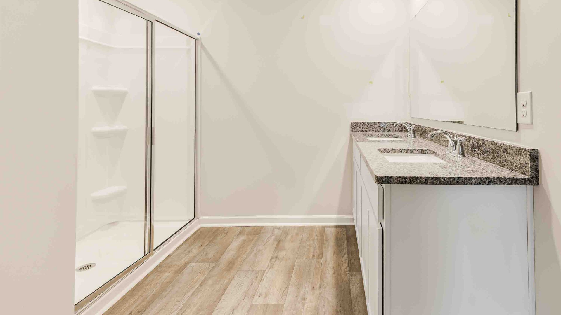 The Primary Suite offers a massive closet and a luxurious bathroom with a walk-in shower, linen closet, and dual vanity.