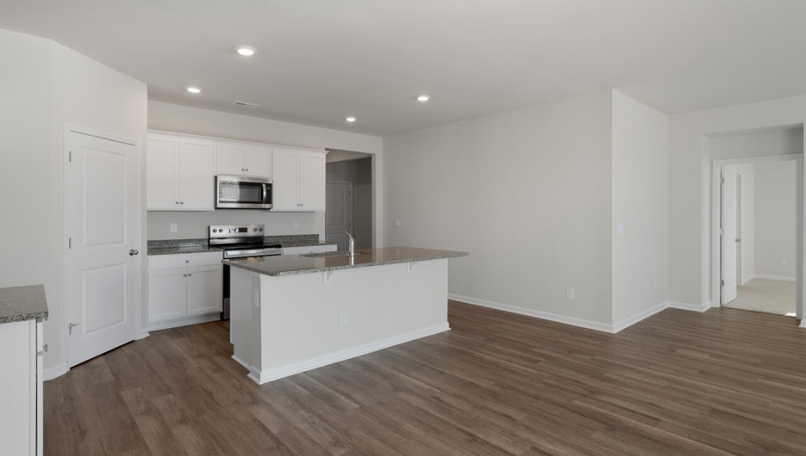 The kitchen features beautiful cabinets, granite countertops, and stainless steel appliances, which are sure to both turn heads and make meal prep easy.