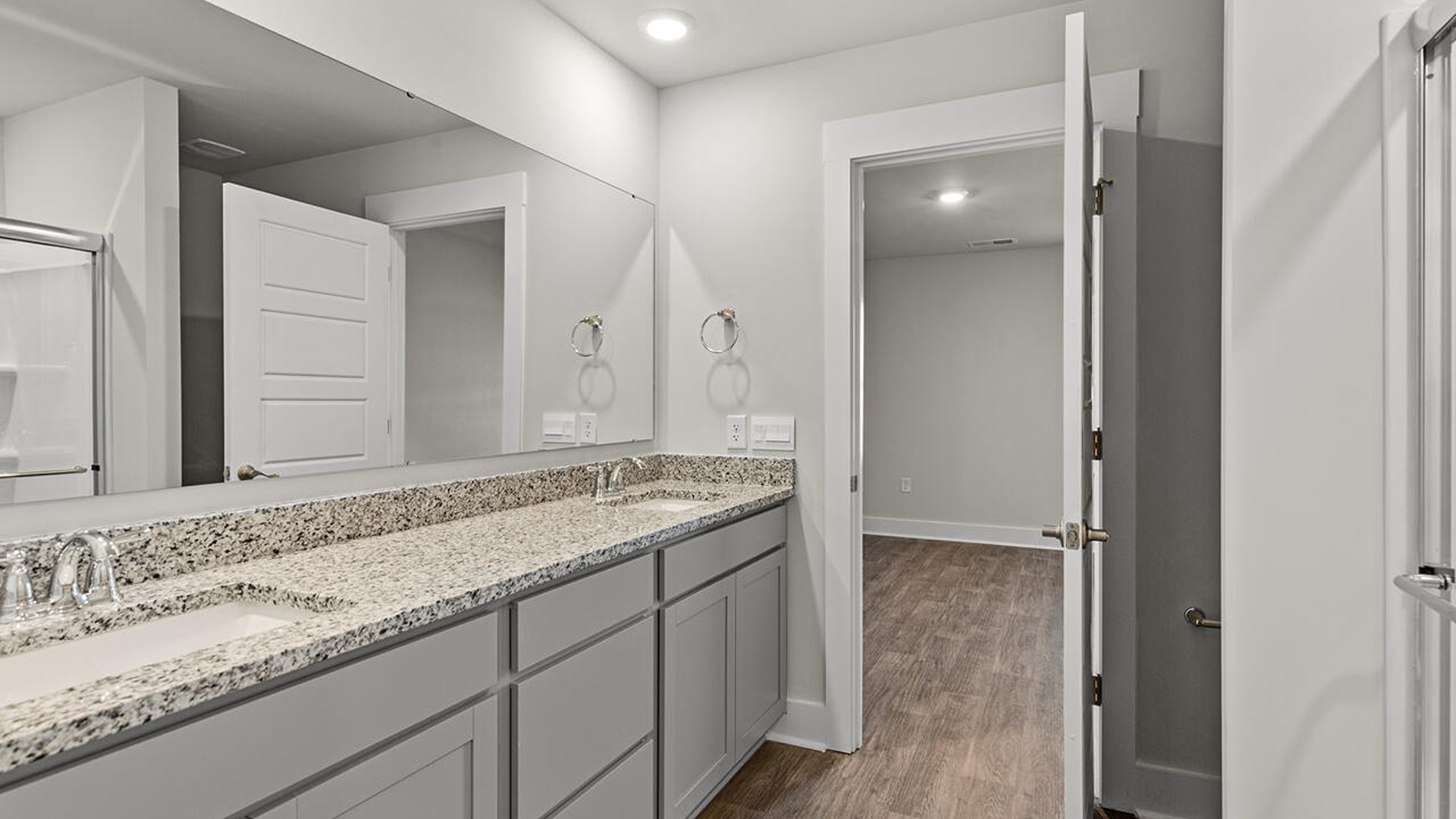 Downstairs is the primary bedroom has its own attached bathroom that features a walk-in closet and all the space you need to get ready in the morning.