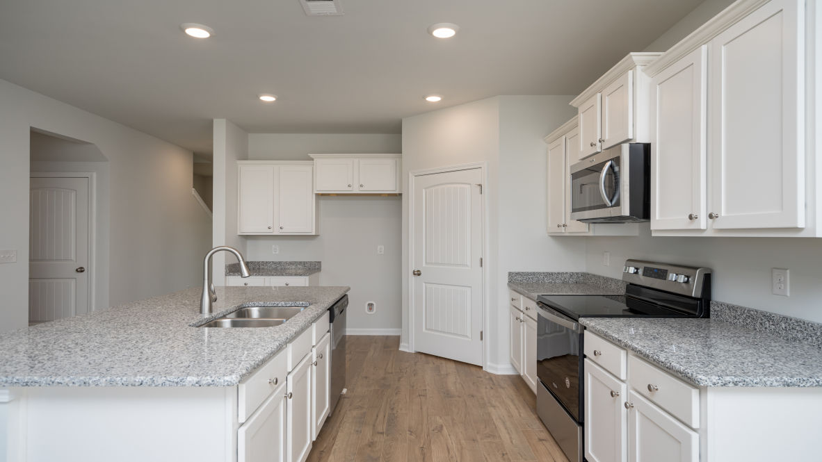 The Elle is a 2,721 sq ft home featuring 5 Bedrooms and 3.5 baths. Its open-concept design includes a kitchen with granite countertops, stainless steel appliances, an island, and a walk-in pantry, while the large great room is ideal for entertaining.