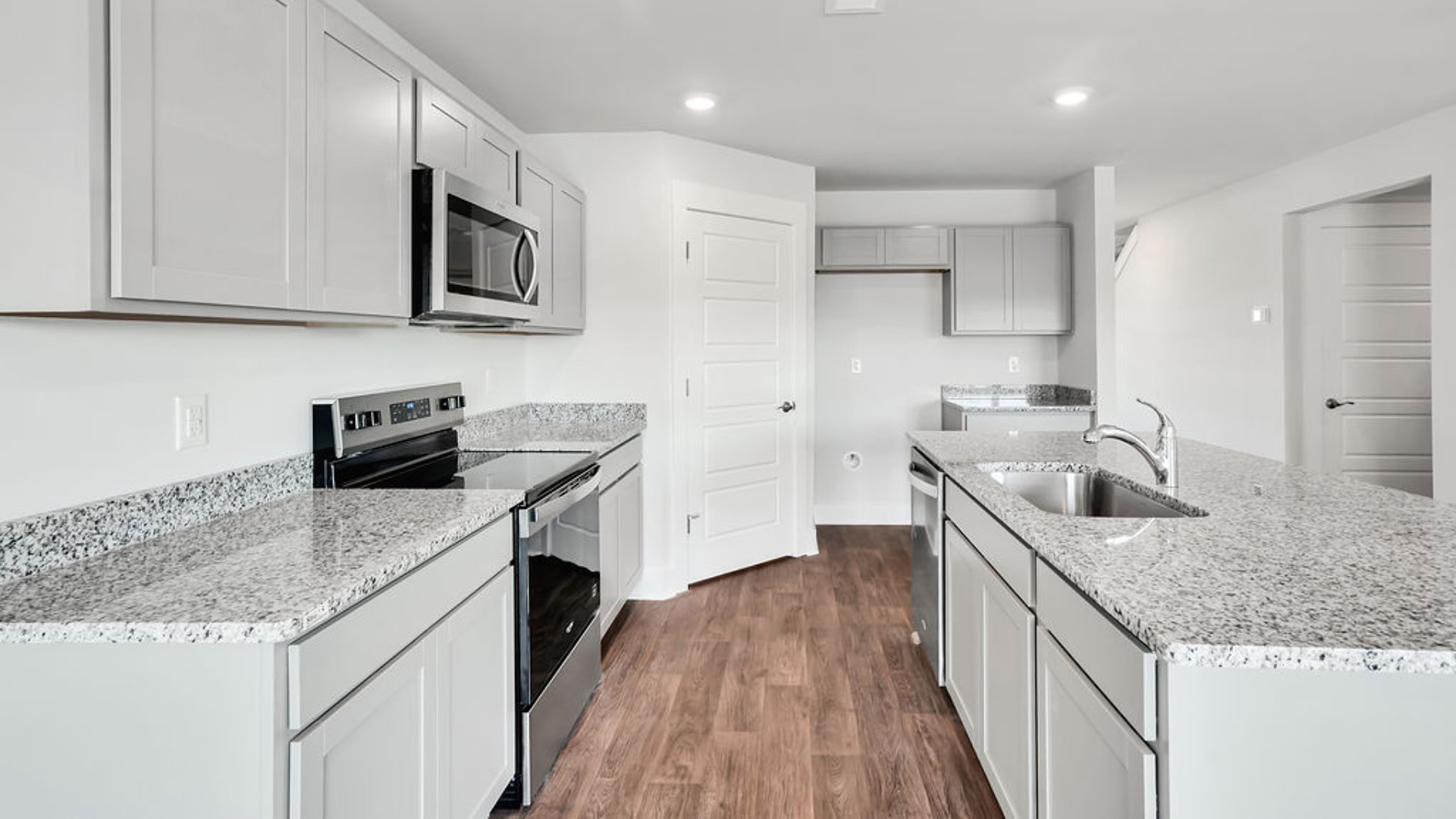 Its open-concept design includes a kitchen with Granite countertops, Stainless Steel Appliances, an island, and a walk-in pantry, while the large Great Room is ideal for entertaining.