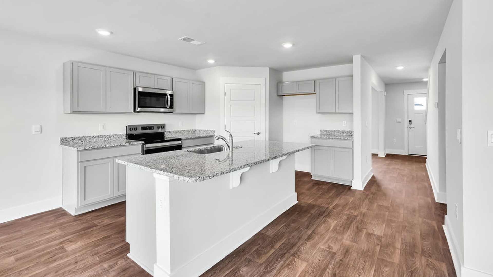 Its open-concept design includes a kitchen with Granite countertops, Stainless Steel Appliances, an island, and a walk-in pantry, while the large Great Room is ideal for entertaining.