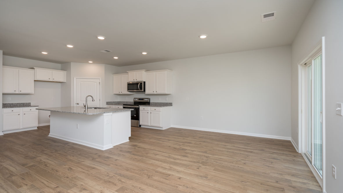 . Its open-concept design includes a kitchen with Granite countertops, Stainless Steel Appliances, an island, and a walk-in pantry, while the large Great Room is ideal for entertaining.