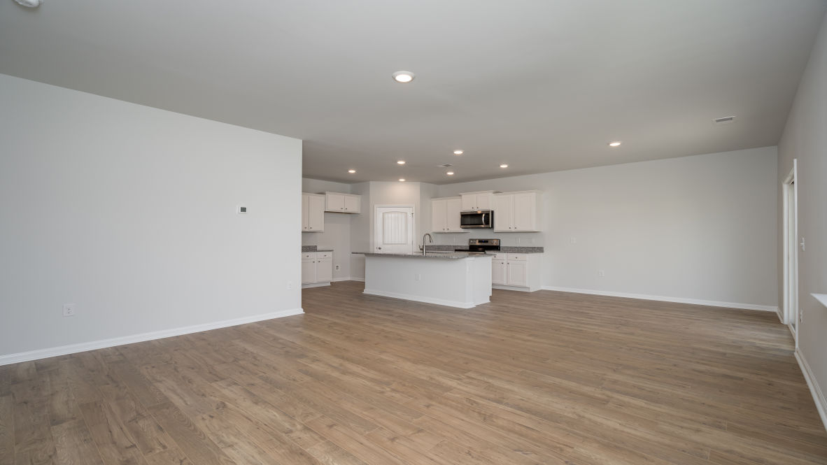. Its open-concept design includes a kitchen with Granite countertops, Stainless Steel Appliances, an island, and a walk-in pantry, while the large Great Room is ideal for entertaining.