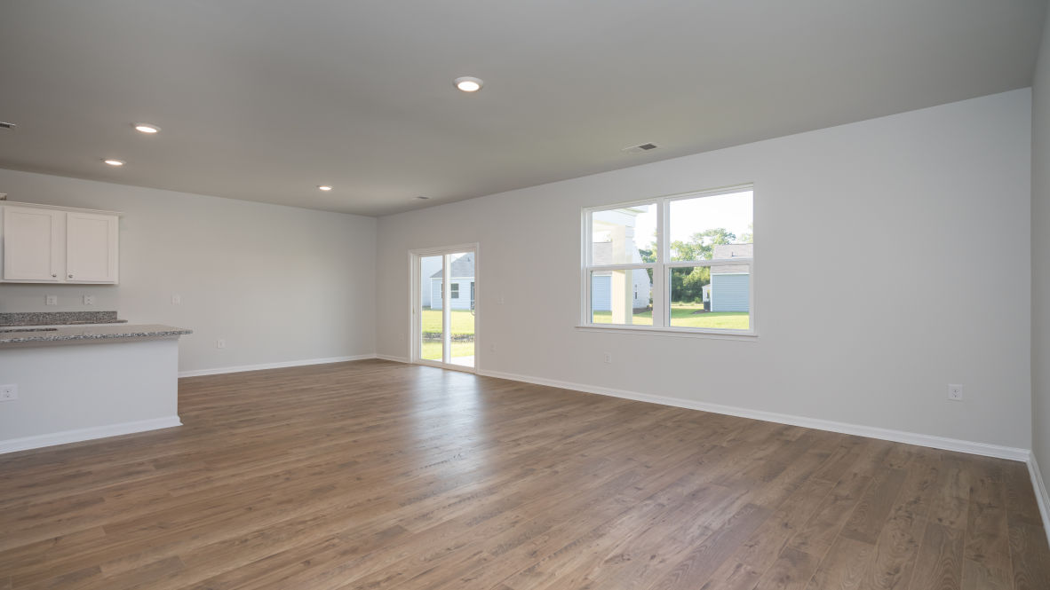 . Its open-concept design includes a kitchen with Granite countertops, Stainless Steel Appliances, an island, and a walk-in pantry, while the large Great Room is ideal for entertaining.